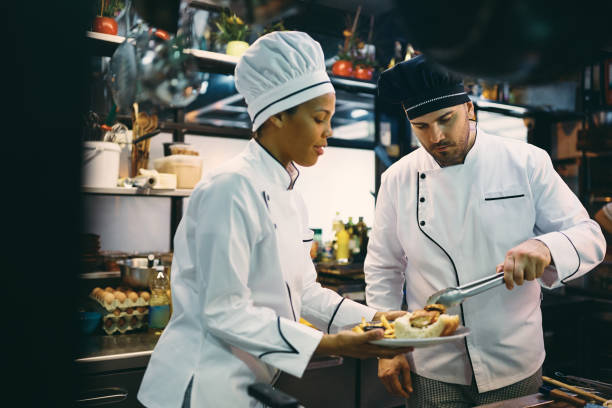 istock Multiracial chefs preparing food in the kitchen at restaurant. 1394056690
