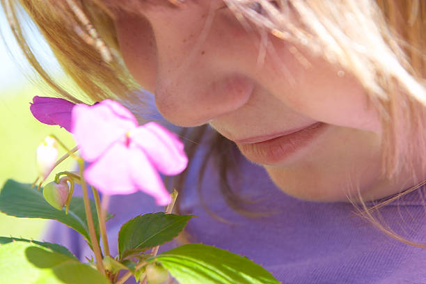 istock Child smelling flowers 139405689