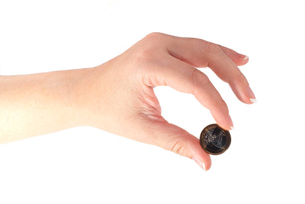 istock Hand holding or dropping Euro coin 139405814