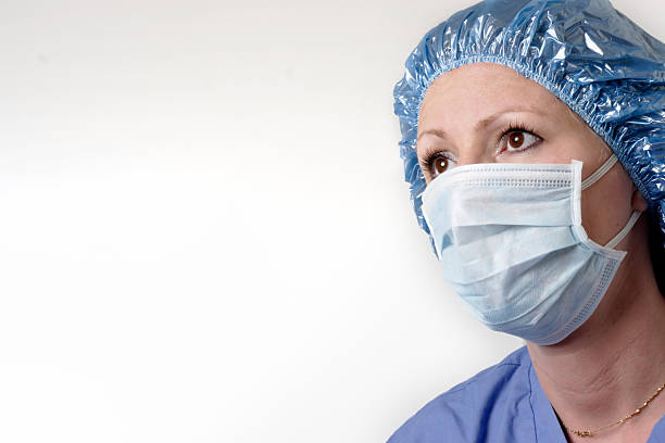 женский хирург на белом фоне - nurse hygiene emotional stress surgeon стоковые фото и изображения
