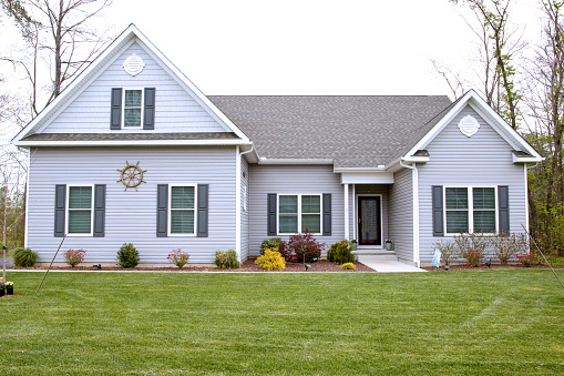 Exterior of home with manicured lawn in the suburbs.