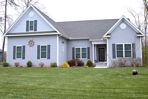 Exterior of home with manicured lawn in the suburbs.