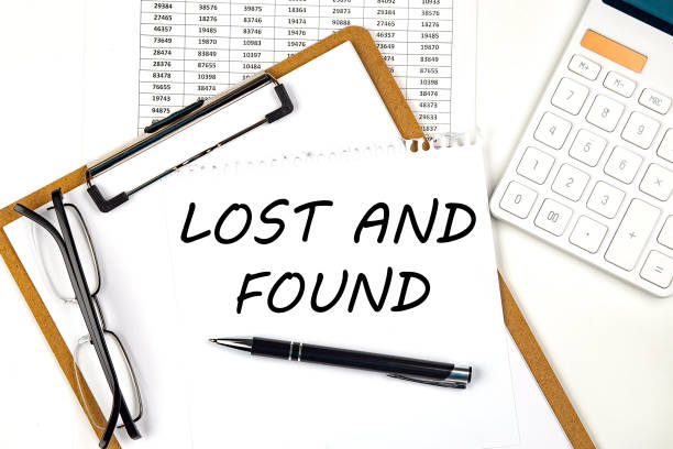 istock Text LOST AND FOUND on the white paper on clipboard with chart and calculator 1394063736