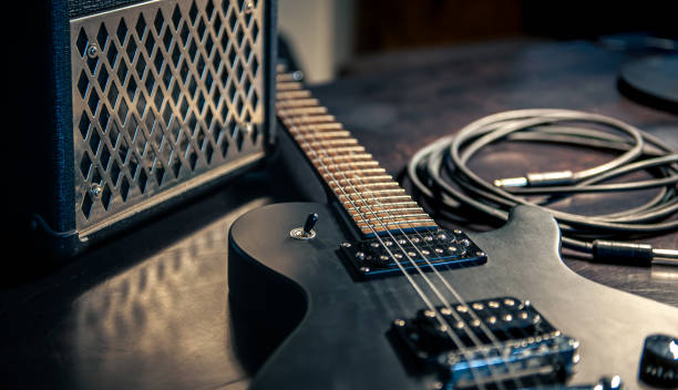 istock Close-up, black electric guitar on a dark background. 1394063793