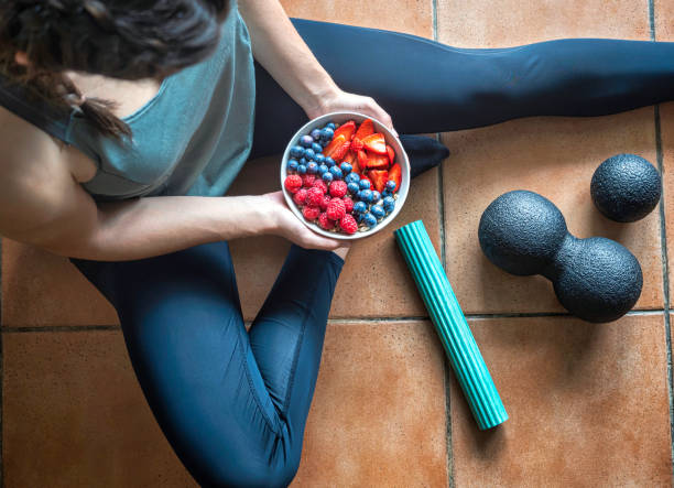 istock Girl holding a cup with berries. 1394063995