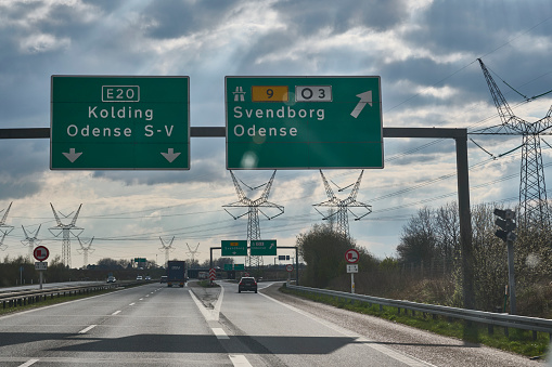 Driving West on the highway outside Odense city. The highway is close to the electrical infra structure.