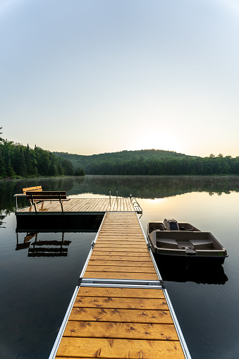 A small and quiet fishing lake in the Laurentides (Laurentians), Quebec, during a sunrise of summer.