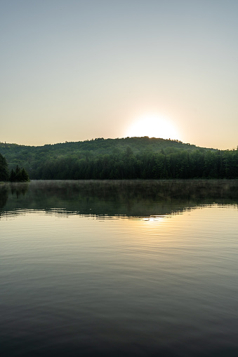 A small and quiet fishing lake in the Laurentides (Laurentians), Quebec, during a sunrise of summer.