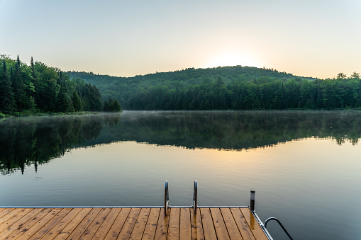 A small and quiet fishing lake in the Laurentides (Laurentians), Quebec, during a sunrise of summer.