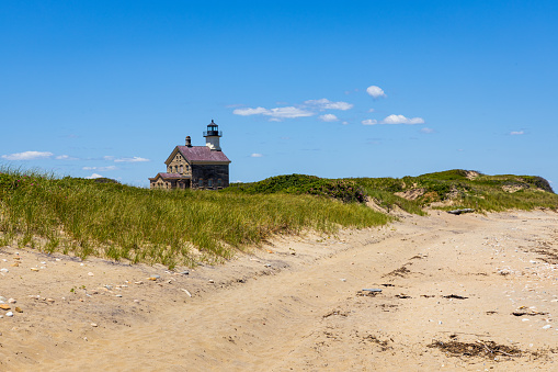 Great Point Lighthouse on Nantucket and the sandy road that leads to it.