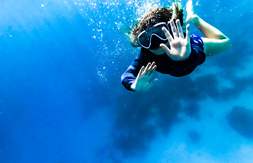 Child swimming underwater in Curaçao