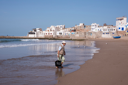 Chtouka-Aït Baha, Morocco - March 02, 2016: Fisherman and landscape on the beach of the coastal town of Tifnit