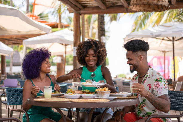 Tourists eating at the restaurant on the beach