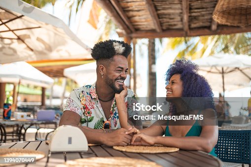 istock Young couple at Brazilian tropical restaurant 1394070449