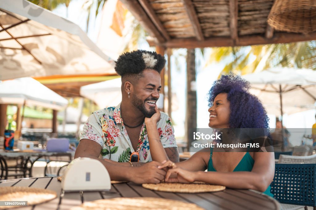 Young couple at Brazilian tropical restaurant Tourists, Pernambuco, Restaurant, Latin America, Brazil Beach Stock Photo
