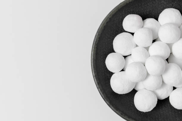 istock White sugar balls on a gray ceramic plate isolated on a white background. Close-up, top view, copy space. 1394071355