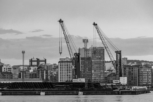 Urban landscape in black and white  where you can see the cranes of the port of A Coruña, in Galicia, Spain