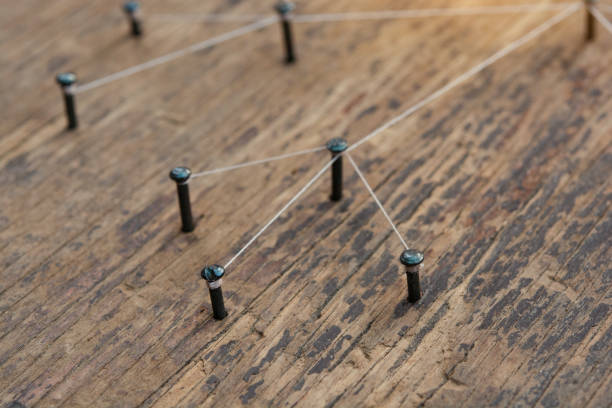 istock Network connected with yarn white on plank wood 1394076656