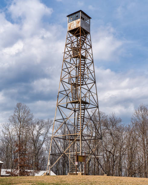 Boundary Peak Lookout Tower near Město Albrechtice, Czechia, offers sweeping views of golden autumn forests and distant hills, framed by brooding clouds above and the tower’s sturdy steel architecture.