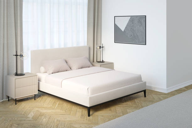 istock Light modern bedroom with a horizontal poster on a white wall, modern lamps on beige nightstands on the sides of a light bed near a curtained window, and a beige carpet on the parquet floor. 1394085843