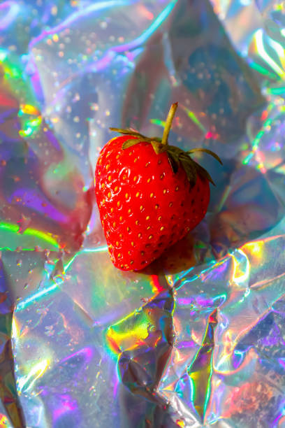 Defocus close-up one ripe red strawberry on modern hologram background. Fruits and berries. Harvest and crop concept. Organic. Trendy gradient. Out of focus