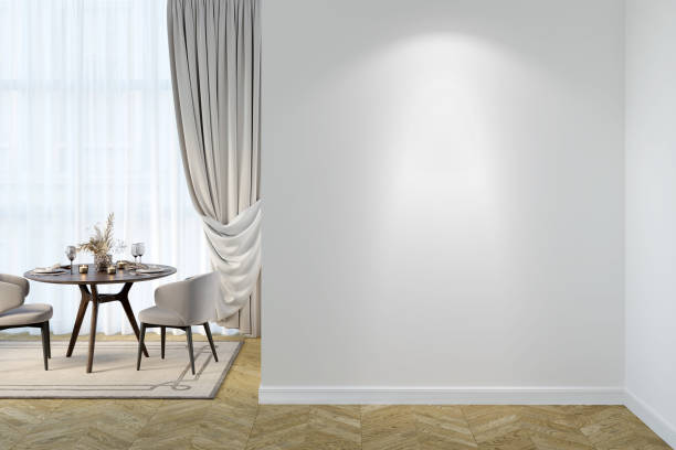 istock A light dining room interior with a blank illuminated white wall, set table with chairs near curtained windows, and beige carpet on the parquet floor. Front view. 1394088062
