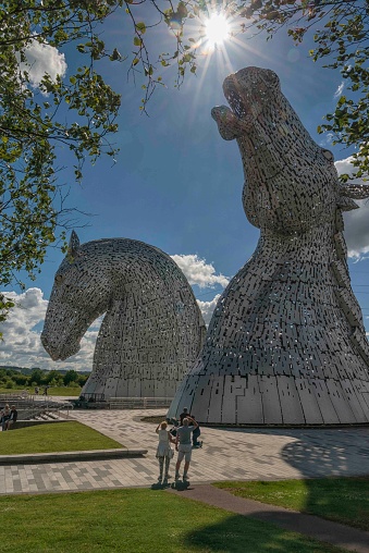 Famous Kelpie horse art sculptures in Scotland against a beautiful blue sunny sky