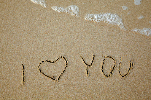 I love you - handwritten on the soft beach sand.