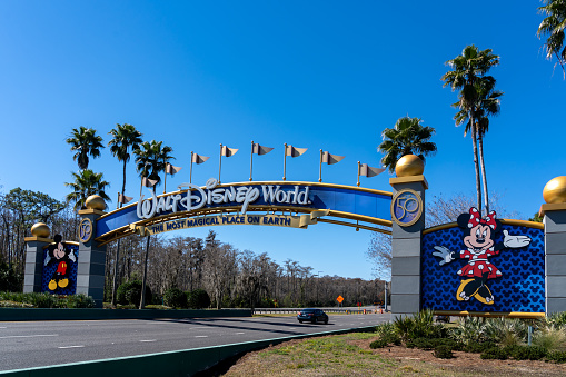 Orlando, Florida, USA - February 9, 2022:  A Walt Disney World entrance arch gate in Orlando, Florida, USA. Walt Disney World is an entertainment resort complex.