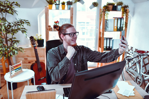 Hipster Freelancer Focused On Video Conference At Home