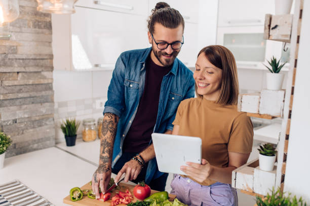 istock Young vegans watching online cooking tutorials and preparing a meal together 1394091565