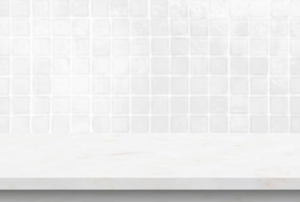 Empty white marble table top with blur tile wall bathroom background stock photo