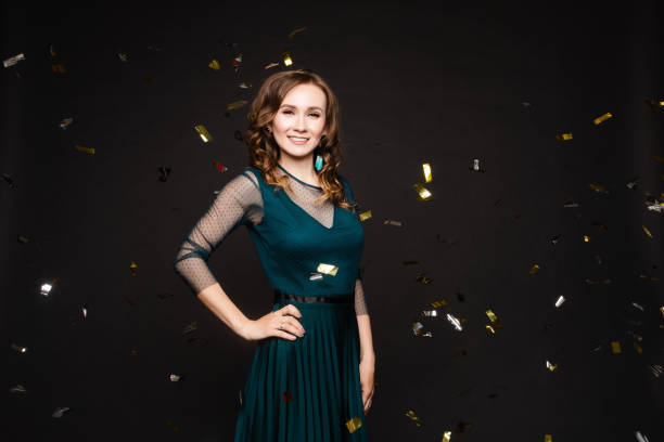 istock Happy young girl looking surprisingly while golden confetti falling. 1394092440