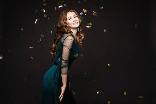 istock Happy young girl looking surprisingly while golden confetti falling. 1394092450