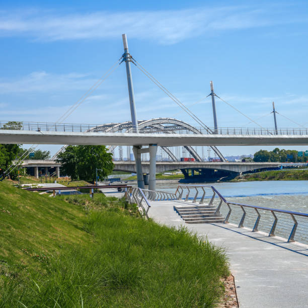 istock A modern park with bridges, grass and modern buildings on a sunny day 1394092840