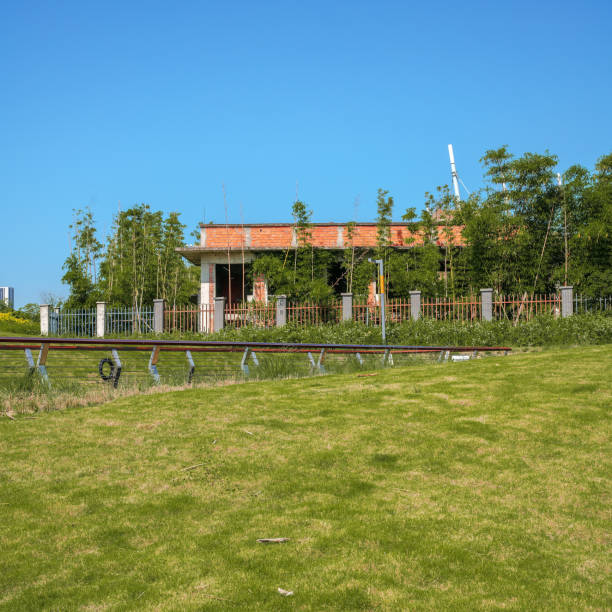 istock A modern park with bridges, grass and modern buildings on a sunny day 1394092852