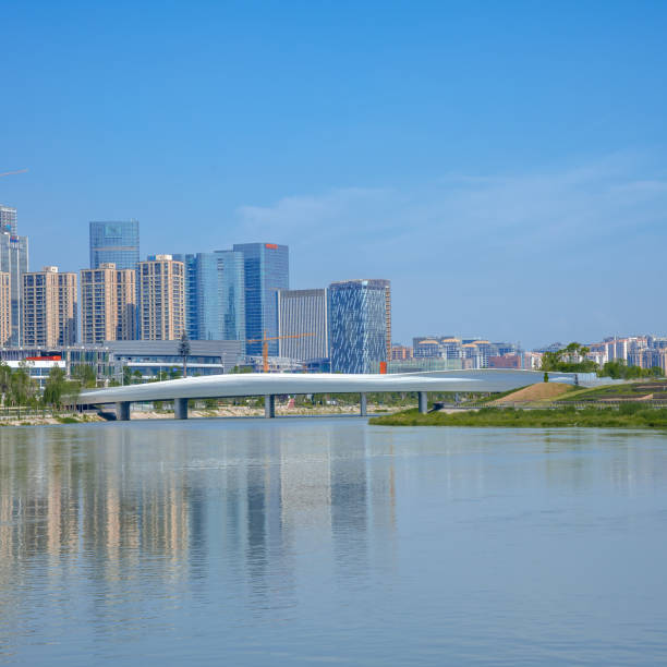istock A modern park with bridges, grass and modern buildings on a sunny day 1394092884