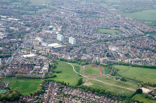 View from above of Feltham Town Centre in Hounslow, West London with the running track, part of Feltham Arenas, in the middle.