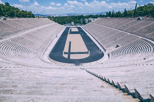 Athens, Greece - April 17, 2022:This stadium is the location for the start of Modern Olympics located in Athens Greece this is also the location for the Olympic Flame to start and travel to the cities of the modern Olympics for the running of the games. This stadium is of course built on ancient ruins the First of the Modern games started here in 1896 and with its Parallelogram Shape on this February Day it was great to enjoy.