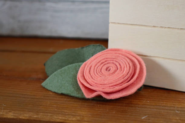 istock Pink Fabric Flower on Wood Background 1394107286
