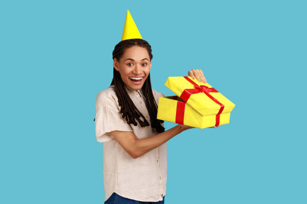 istock Amazed woman looking into gift box, opening present and looking at camera with happiness. 1394110982