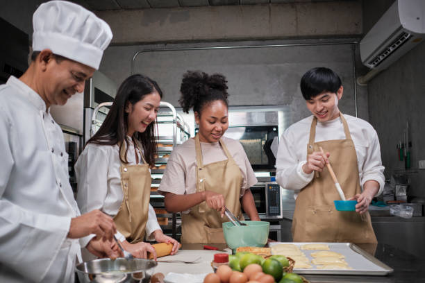istock Senior chef teaches cooking students to prepare pastry dough for fruit pies. 1394111906