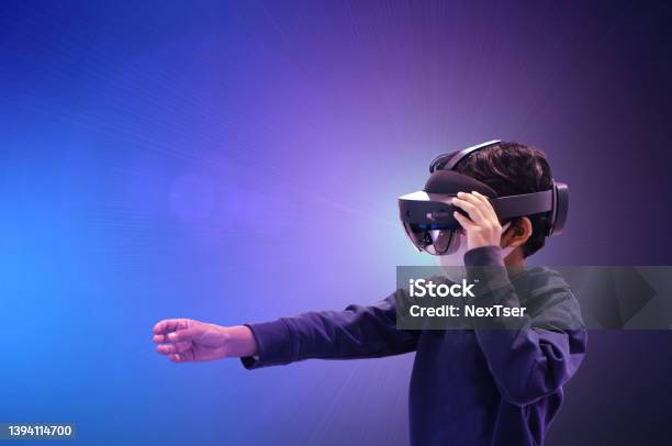 Asian Kid Boy Using Metaverse Vr Virtual Reality Glasses Stock Photo - Download Image Now