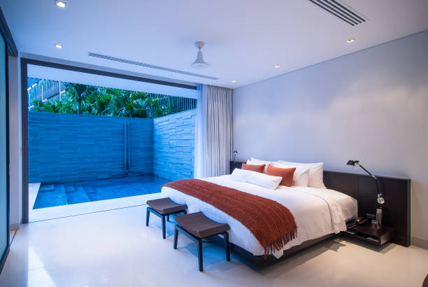 istock Luxury Hotel bedroom suite poolside view 1394117412