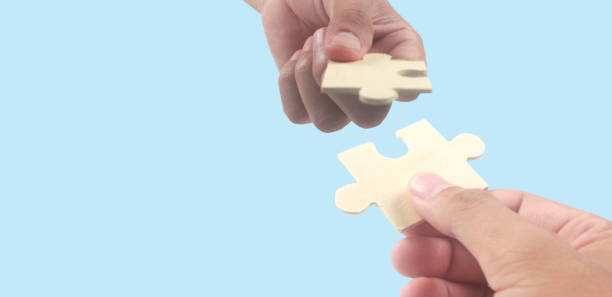 istock Connecting jigsaw puzzle in  hand 1394118102