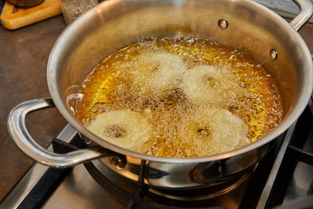 istock Cooking apple pancake. Apple donut in boiling oil 1394119617