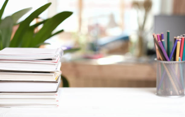 istock home workspace with books and color pencils on white table. copy space for product placement. learning at home or distant education. 1394122210