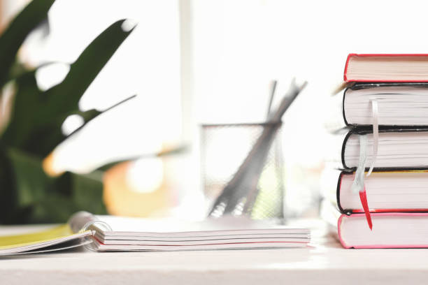 istock A stack of textbooks on the windowsill and writing stationary 1394122223