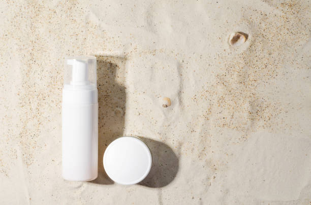 istock Sun protection. Cream, lotion, ointment for sunbathing on the sand 1394122331