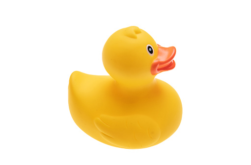 Yellow plastic duck isolated cutout on white background. Baby bath traditional fun toy, rubber duckling that floating. Overhead view.